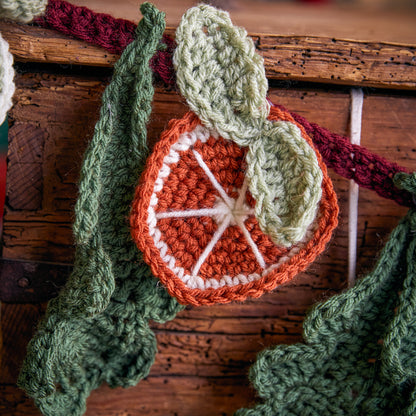 Red Heart Festive Abundance Crochet Garland Festive Abundance Crochet Garland made using Red Heart yarn in a styled lifestyle setting