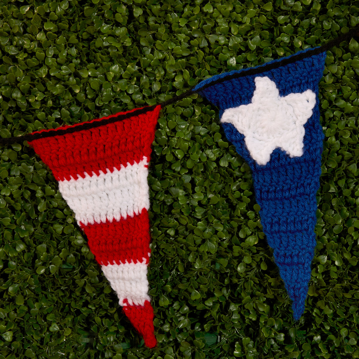 Stars And Stripes Crochet Pennant Banner made using Red Heart yarn in a styled lifestyle setting