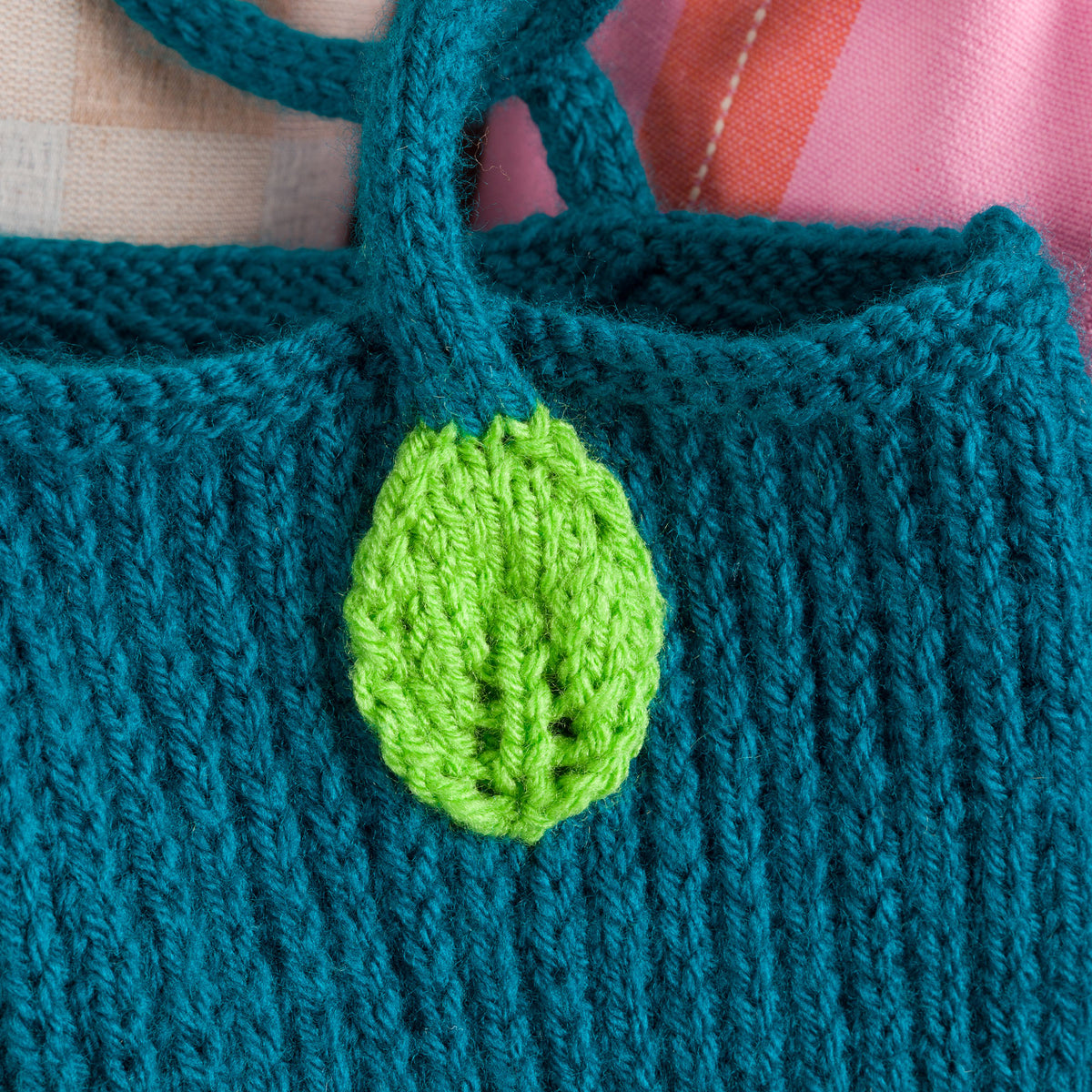 Knit Floral Tote made using Red Heart yarn in a styled lifestyle setting