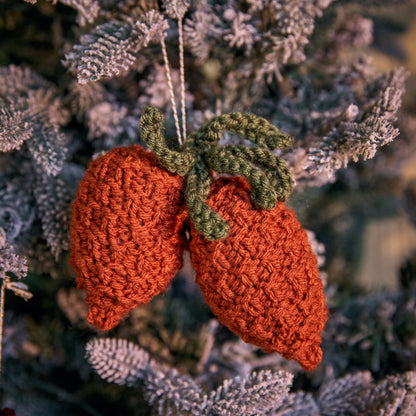 Red Heart Acorn & Pinecone Knit Ornaments Acorn & Pinecone Knit Ornaments made using Red Heart yarn in a styled lifestyle setting