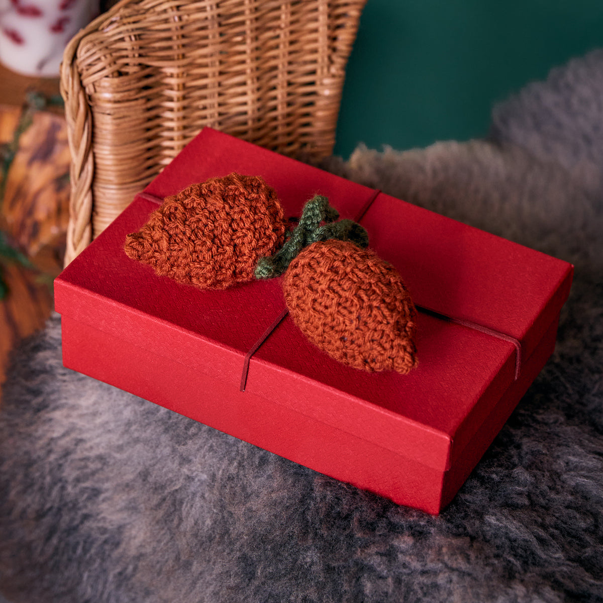 Acorn & Pinecone Knit Ornaments made using Red Heart yarn in a styled lifestyle setting