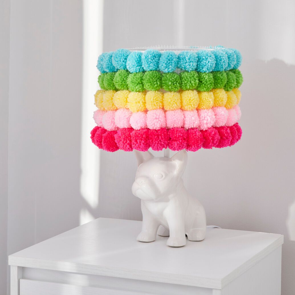 White dog lamp with pom pom shade